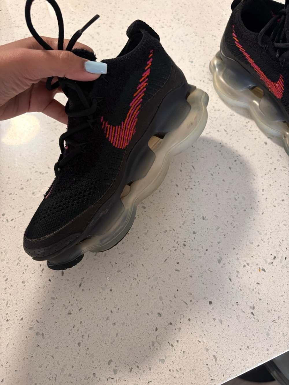 Nike Black Flyknit Sneakers with Red and Orange Swoosh